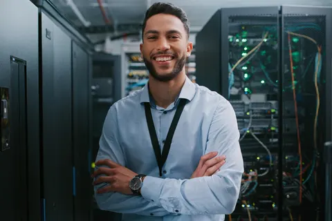 Adam, your local True Blue Tech technician, smiling in the server room